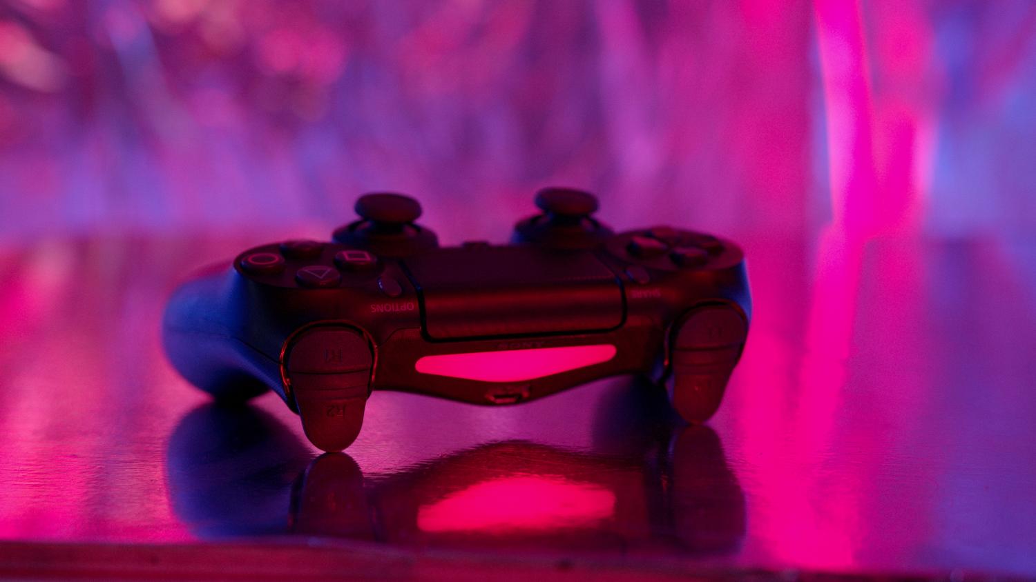 Mando de videojuegos estilo DualShock con iluminación de neón vibrante en tonos rosa y púrpura, estilo cyberpunk.