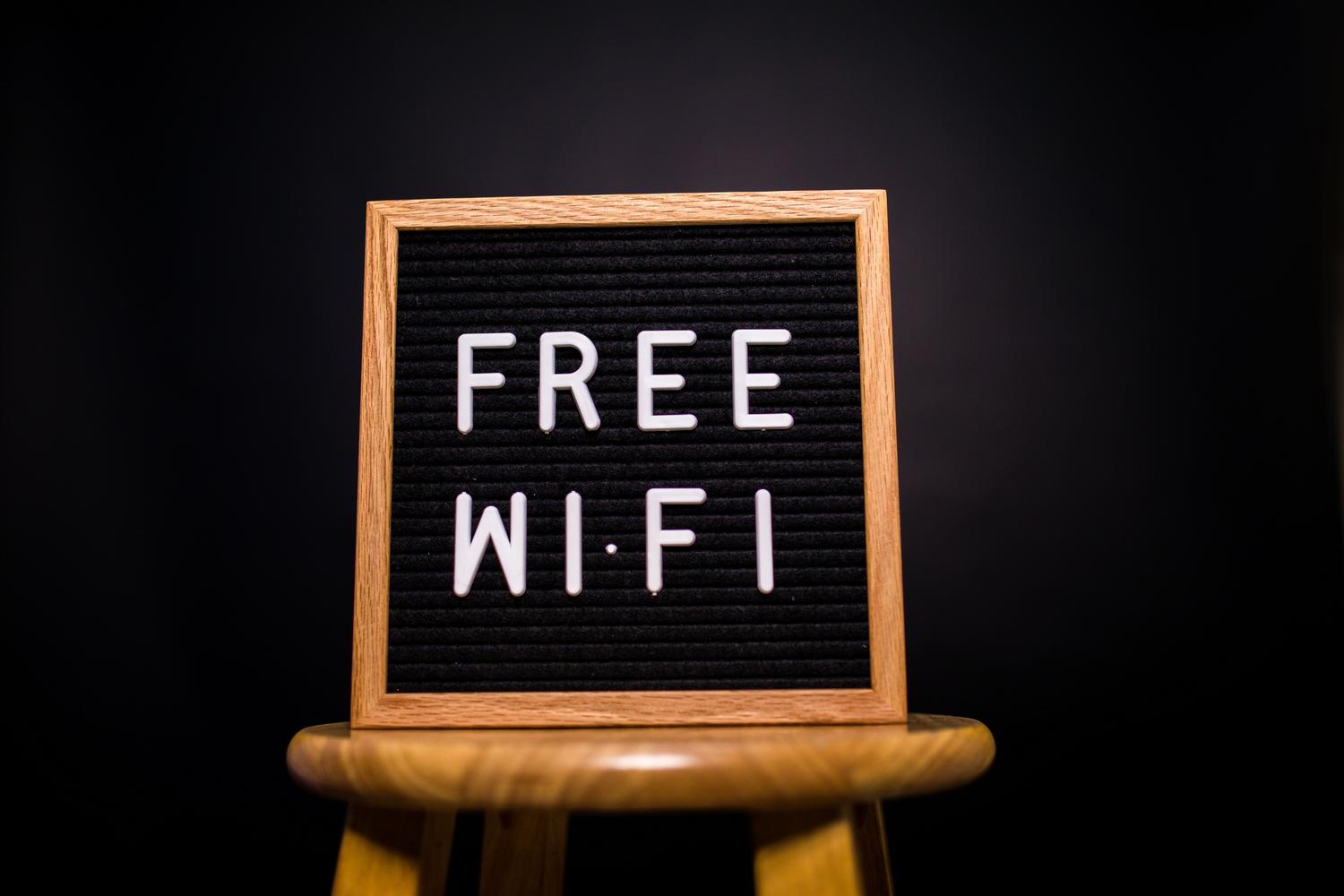 A wooden sign indicating 'Free Wi-Fi', illustrating the concept of a network for guests.