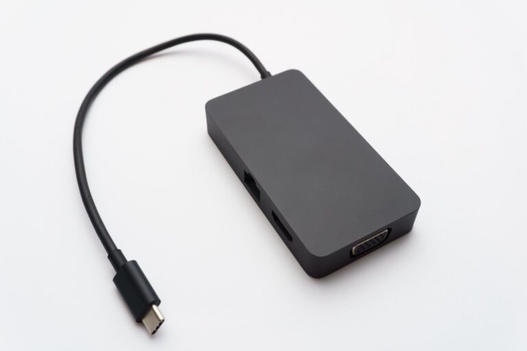 Primer plano de un concentrador USB-C sobre un fondo blanco, ilustrando los periféricos que pueden activar la reinstalación de software.