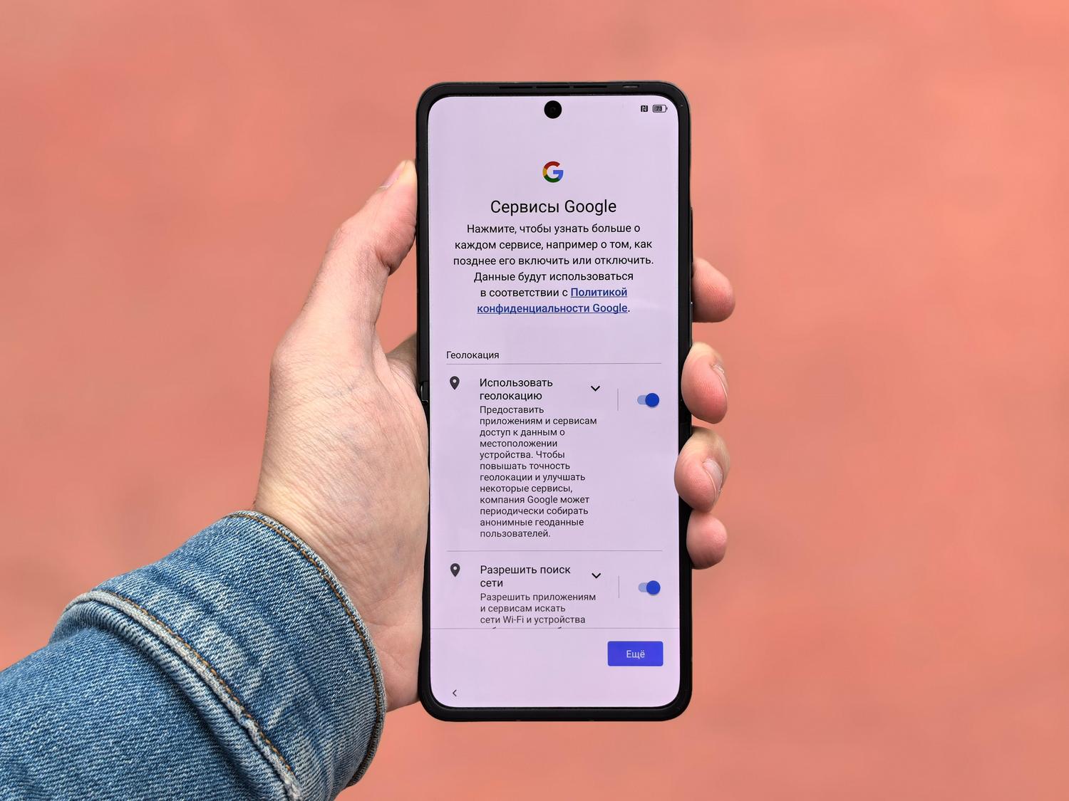 Persona sosteniendo un smartphone mostrando el menú de ajustes, ilustrando la gestión de aplicaciones en Android e iOS.