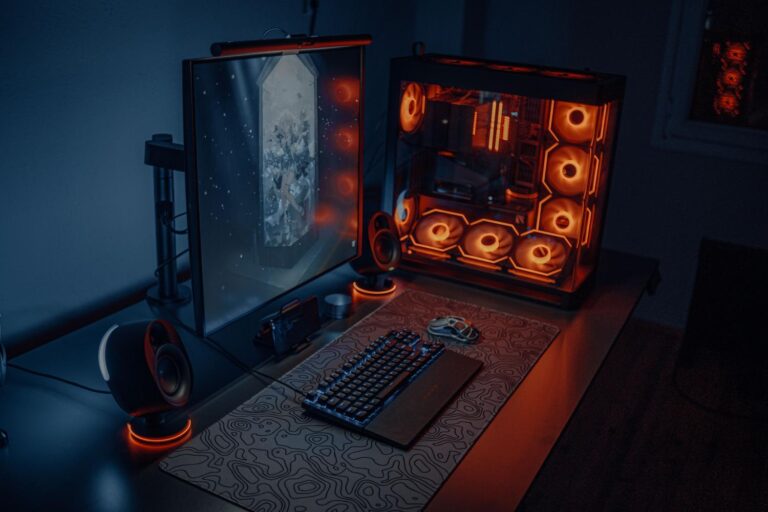 Setup de PC gaming de alta gama con iluminación RGB naranja, representando la máquina servidor para el streaming de juegos.