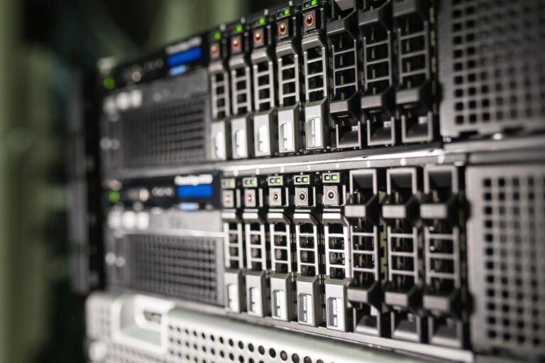 Close-up of professional server hardware in a modern data center, showing drive bays and status LEDs.