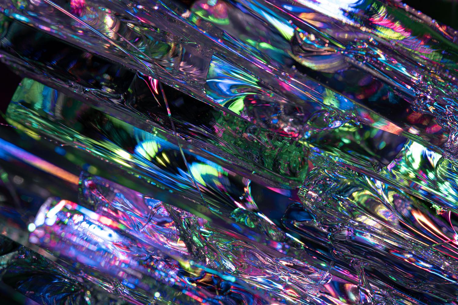 Material iridiscente con reflejos de colores que representa los efectos de cristal y luz de OriginOS 7.
