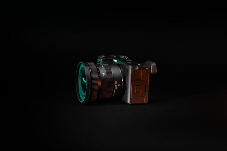 Professional mirrorless camera on a dark background with cinematic lighting, representing C2PA hardware signing.