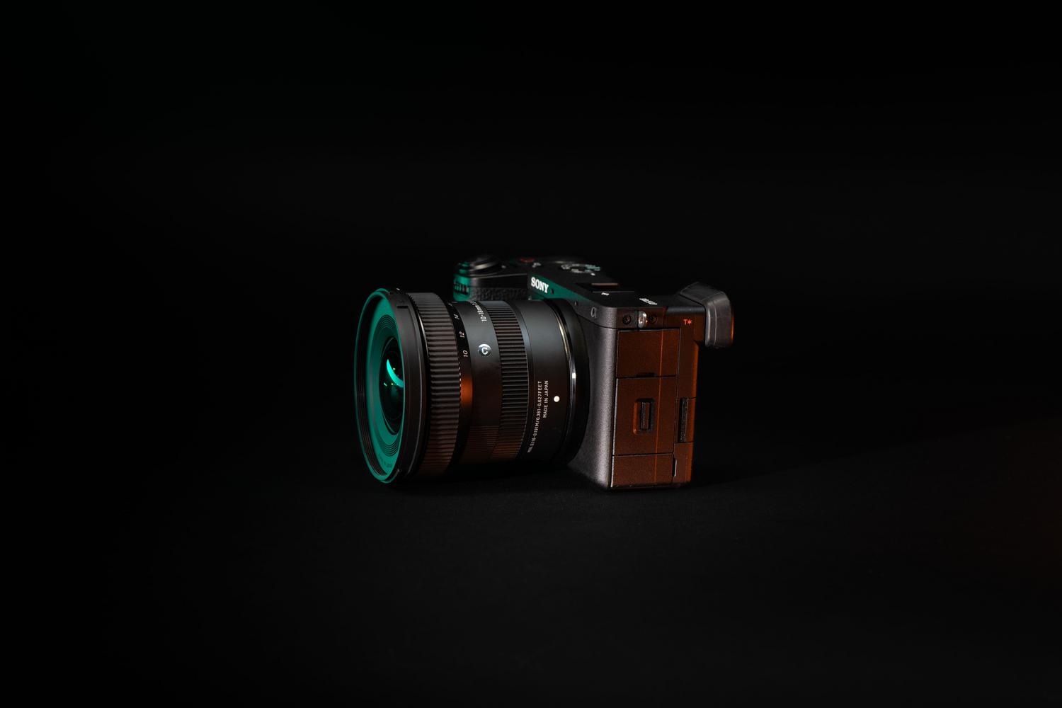 Professional mirrorless camera on a dark background with cinematic lighting, representing C2PA hardware signing.