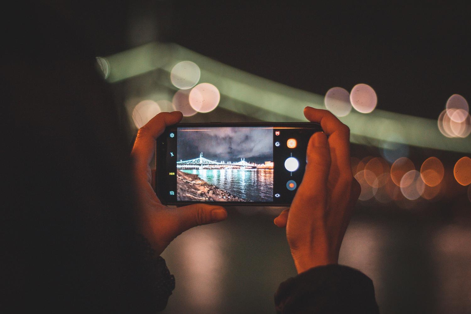Captura nocturna de una ciudad con luces bokeh, mostrando el procesamiento computacional de imagen.
