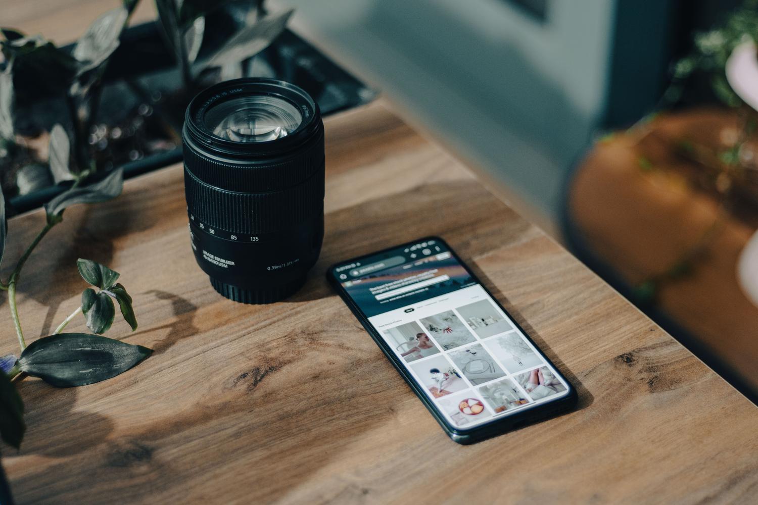 Móvil y equipo fotográfico en un espacio de trabajo creativo.